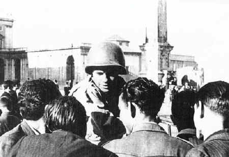 Alfonso Felici, 3rd Bn, 349th, gives the news to the civilians on liberations day in ROME, 4 june 1944.  He's in the piazza in front of St. John in Laterano